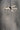 ET2 Rollo tube pendant against a mottled gray concrete wall, seen from below