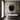 Two Roma wall lights either side of a round mirror above a freestanding bath in a bathroom with an arched window