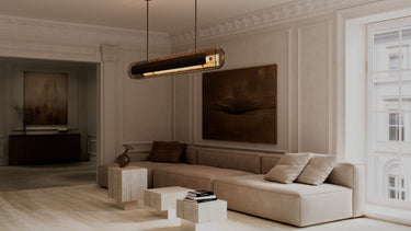 Contour pendant light hanging over a sofa in a large living room