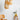 Lit Drop pendant glowing beside a chair in a styled room, Graypants Scraplights lifestyle photograph