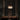 ET2 Sense mirror chrome flush mount glowing over a dark wood dining table in a room with tall charcoal drapes