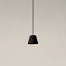 Black ribbon Sísísí Cónicas PT1 pendant lamp by Santa & Cole with black ceiling canopy and warm ambient lighting