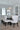 ET2 Spiral rectangular crystal bead pendant above a dining table with white chairs beside a tall window, close view