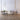 ET2 Stillo teardrop glass pendant cluster hanging over a white sofa in a paneled living room