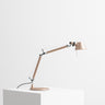 Artemide Tolomeo Micro adjustable table lamp in brushed copepr on a modern desk