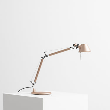 Artemide Tolomeo Micro adjustable table lamp in brushed copepr on a modern desk