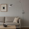 Artemide Tolomeo wall-mounted adjustable task light with S bracket and dimmable articulated arm in a contemporary living room