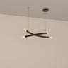 Trace Linear X chandelier with two crossing curved bronze strands and glass shades, studio view