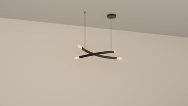 Trace Linear X chandelier with two crossing curved bronze strands and glass shades, studio view
