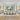 ET2 Unity looping linear pendant over a long dining table in a formal dining room with two large paintings