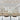 ET2 Unity looping linear pendant on a high ceiling above a dining table with white chairs