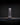 Lambda lamp by Teukho in Black, end-on profile on a dark surface