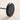 Underside of the Black Moneta Medium base disc resting on a pale wood floor