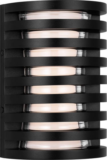 Quoddy 9 Outdoor Wall Light by Sean Lavin in Outdoor Black, lit three-quarter view of the louvered cylinder