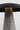Detail of the Dark Bronze shade edge and travertine stem on the Aegis Medium table lamp