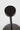 Detail of the Moneta Short Accent lamp's Black disc head and slim stem