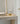 Caspe 7 lamp seen from across a room on a console table next to a mirror
