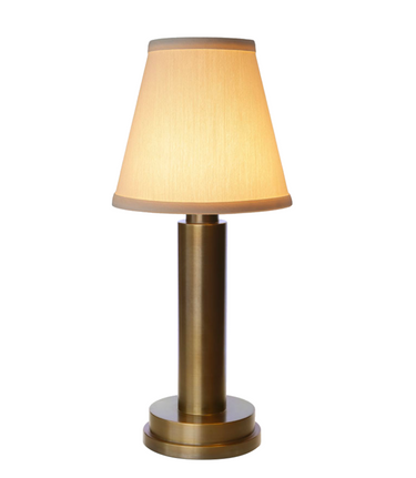 Portable battery-powered lamp, Victoria, with cotton shade, in a modern living room setting.