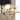 Crosby black and brass chandelier photo, featuring adjustable stems and optional brass cap, luxury dining room lighting.