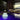 Zen Bluetooth LED Cordless Lamp by Smart & Green glowing teal at a poolside pergola - LoftModern