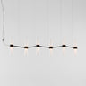 Zephyr linear LED suspension light by Artemide with clear glass diffusers black finish