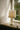 Acropolis table lamp on a sunlit window ledge beside a leaded window