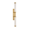 Alo Extra Large Wall Sconce in polished natural brass with handcrafted fluted glass, illuminating a modern bathroom vanity.