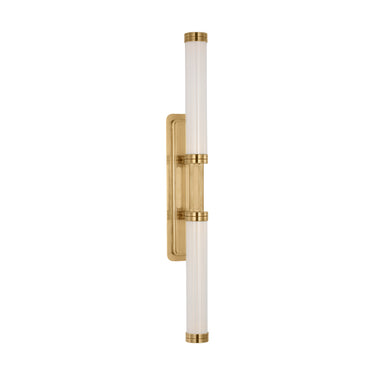 Alo Extra Large Wall Sconce in polished natural brass with handcrafted fluted glass, illuminating a modern bathroom vanity.