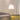 Artemide Tolomeo Mega Parchment LED floor lamp extending over modern sofa