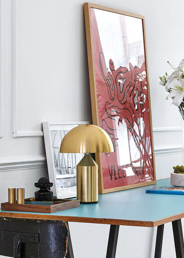 Designer table lamp Atollo Gold by Vico Magistretti in living room