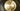 Close-up of the brass disc and smoked glass shade of the Pendulum pendant light