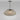 Petra pendant with a smoked pebble-like outer glass shade on a bronze rod, studio view