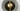 Close-up of a Pendulum pendant light in satin brass seen from above, with a smoked glass shade