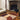 Bijoux Précieux wool rug in Brown, styled in a room