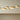 Group of Anvers ceiling lights in satin brass in different sizes on a pale ceiling
