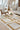 Ciutadella jute rug in Gold, styled in a room