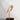 Daqiconcept Bird LED Dimmable Desk Lamp - Almond Beige illuminating a book on a bedside table