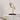 Warm, inviting light from Daqiconcept Bird LED Dimmable Desk Lamp - Almond Beige in a cozy reading nook