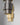 Close-up of two Ring pendants, one in bronze and one in satin brass, with brass interiors