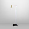 Heron floor lamp in satin brass on a black Marquina marble base, studio view