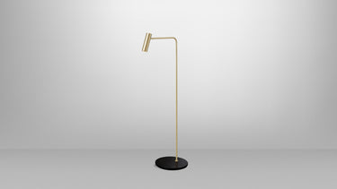 Heron floor lamp in satin brass on a black Marquina marble base, studio view