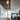 Penta Glo floor lamp, a glass sphere on a slim metal stand, lit in a living room