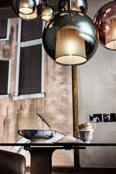 Penta Glo pendant lights, glass spheres hanging over a dining table