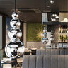 Reflective mini pendant light with sculptural stainless steel design for ambient lighting for restaurants and hospitality projects