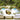 Pair of white Cot twin daybeds with striped pillows and a fruit basket beside a garden pond with palms
