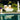 White Crib queen daybed with Lean wedge headboards and tan pillows on a lawn beside a pool with a classical statue