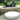 White Footnote oval floor pad in front of a garden sculpture