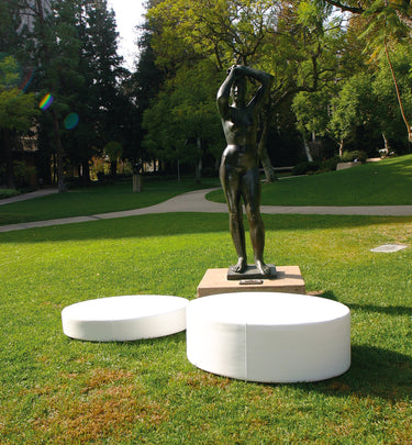 White Footnote and Note oval pads on a lawn in front of a bronze figure sculpture