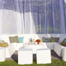 Romp Club Now cabana set in white vinyl: a U-shaped sectional of lounge chairs and corner modules with ottomans on a lawn under sheer curtains