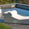 Surf lounge with its pillow beside a pool